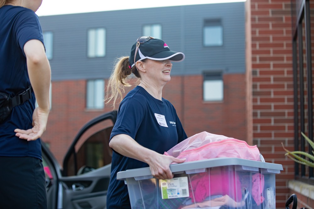 GVSU alumna carries clear bin in front of Holten Hooker dorm